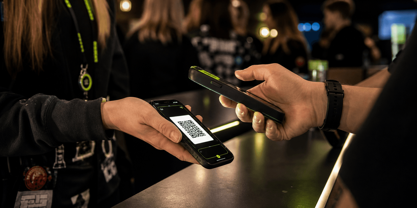 Venue staff scanning a student QR code at a checkpoint.